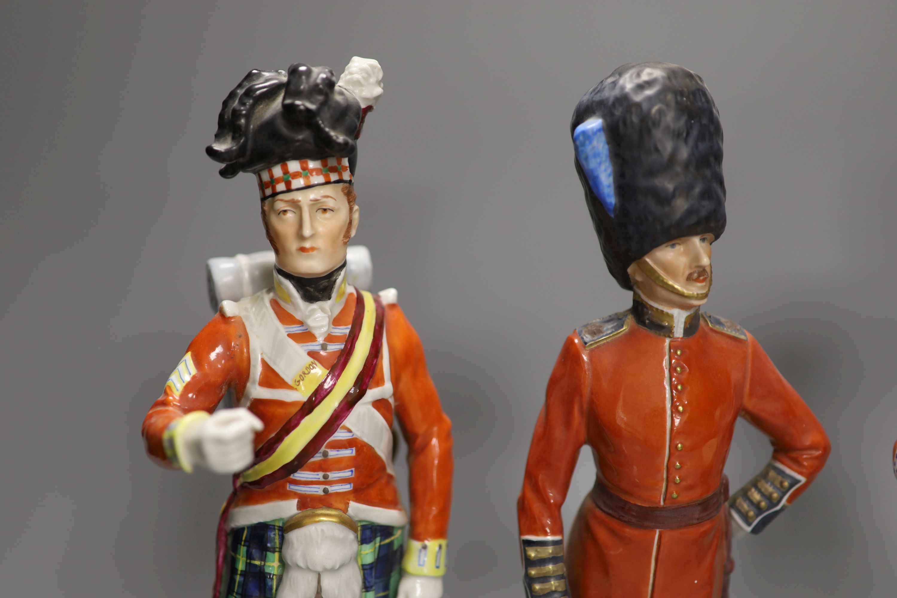 Four Dresden porcelain models of soldiers: Irish Guards, Drummer 3rd Guards, The Welsh Guards and Gordon Highlanders, height 28cm